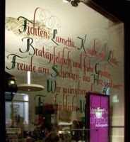 No writing on the wall but on a (shop) window.