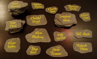 Nobody ever said place cards have to be made out of paper, right? Here the names were written on pieces of slate for the wedding of a teacher for roofers/slaters.